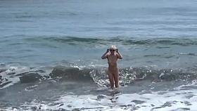 Cute blonde gets off on public beach