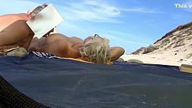 Topless woman with large breasts filmed in secret at the beach