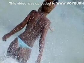 Girl with a sexy bikini enters the water