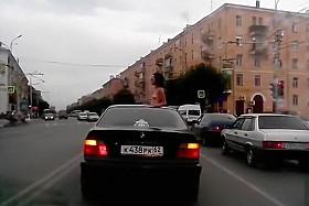 Topless babe riding in a BMW while in Russia