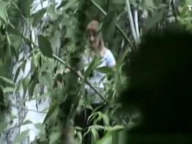 Woman and friend peeing outdoors