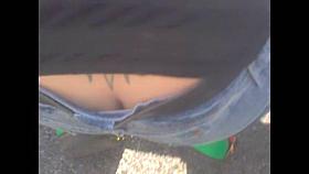 Street candid view of girl in low waist blue jeans