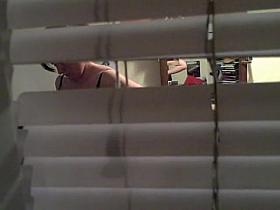 Real amateur nudity spied through the louvers on window