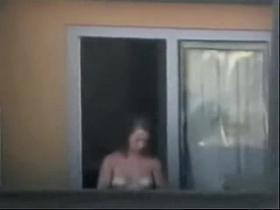 Sexy neighbor showing off her white tits in the window