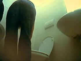 Curly girl spied tinkling with a hidden cam