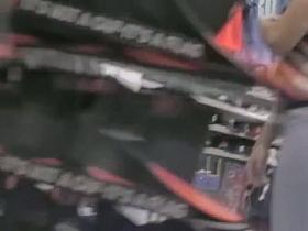 Street candid brunette in blue jeans walks in the local shop