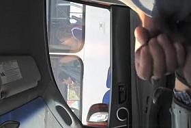 Guy strokes his cock in traffic next to woman in bus