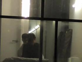 Voyeur neighbor films couple through window