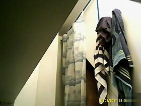 Delicious floozy shows off her big jugs and shaved pubis to a hidden cam