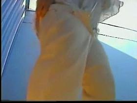 Girl in changing room has dressed up her white pants