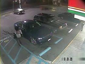 Desperate black woman soaks the parking lot next to the car