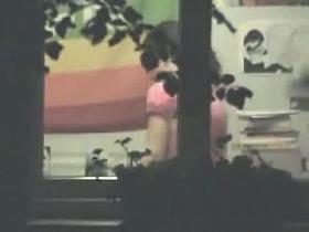 Cute chick caught on cam by a window voyeur.