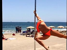 Blonde lass doing her pole dancing show