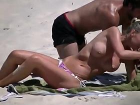 Voyeuring a topless girl's big fake tits