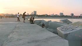 Brunette in metal shackles in public