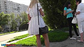 Sexy blonde in white dress lures up skirt camera