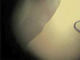 Amateur female leaning towards the spy camera in change room