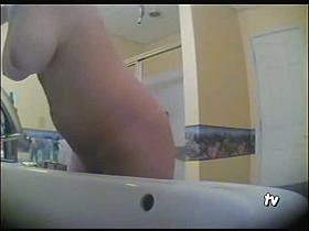 Girl with giant tits steps on the scale before showering