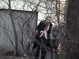 Girls pissing behind bush