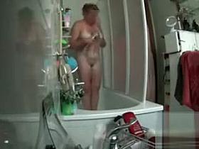 Chubby cougar strips down naked and washes her curvaceous body