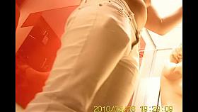 Fem in light summer trousers in the changing room