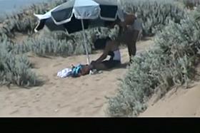 Couple spied in the beach fucking under the sun umbrella