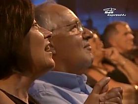 Stripping magic act on stage at a festival