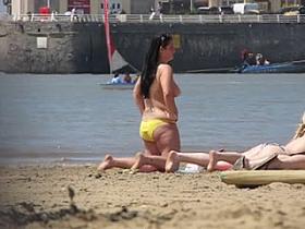 Chubby beach brunette topless