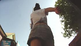 Colorful skirt is moving her ass down the street on the vid