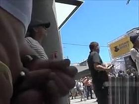 Old daddy strokes his thick dick in a crowd of naked people