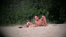 Erotic nude beach video of a couple carresing each other