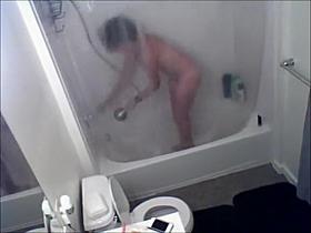 Short-haired babe is recorded while showering