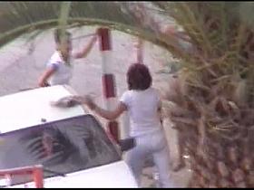 Mature and absolutely hot woman pissing in front of a car