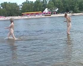 Naughty young nudists play with each other in sand
