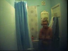 Big breasted blonde captured on a shower spy cam