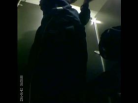 Girl slowly dressing up in darkness on changing room spy cam