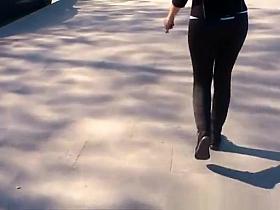 Long hair redhead in tight black sports pants