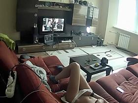 Spying a girl rubbing pussy to some porn