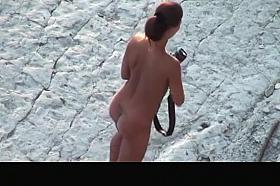 Nude woman with pierced belly and tattoo