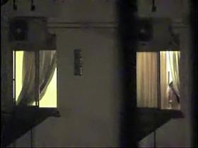 Naked bimbo at the window spied on cam by the neighbor