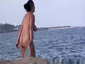 Nudists playing racquet ball and beach volley