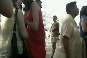 Slim raven-haired queen has her panties adjusted in public