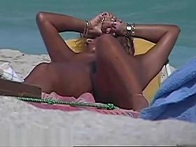 Stripped breasty honey widens legs at the beach