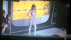 Scantily clad Miley Cyrus poses for photographers