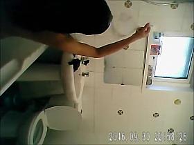 Bathing woman washes her long dark hair