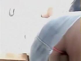 Sexy pink pantie in short jeans skirt