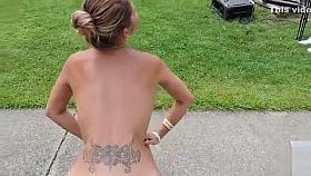 Naughty nudist does a headstand for the crowd