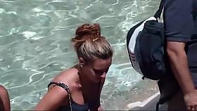 Busty teen girl sitting on a fountain