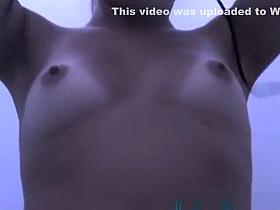 Girl changing in beach cabin.