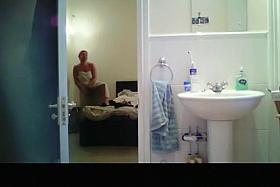 Hidden camera in bathroom catches busty chick